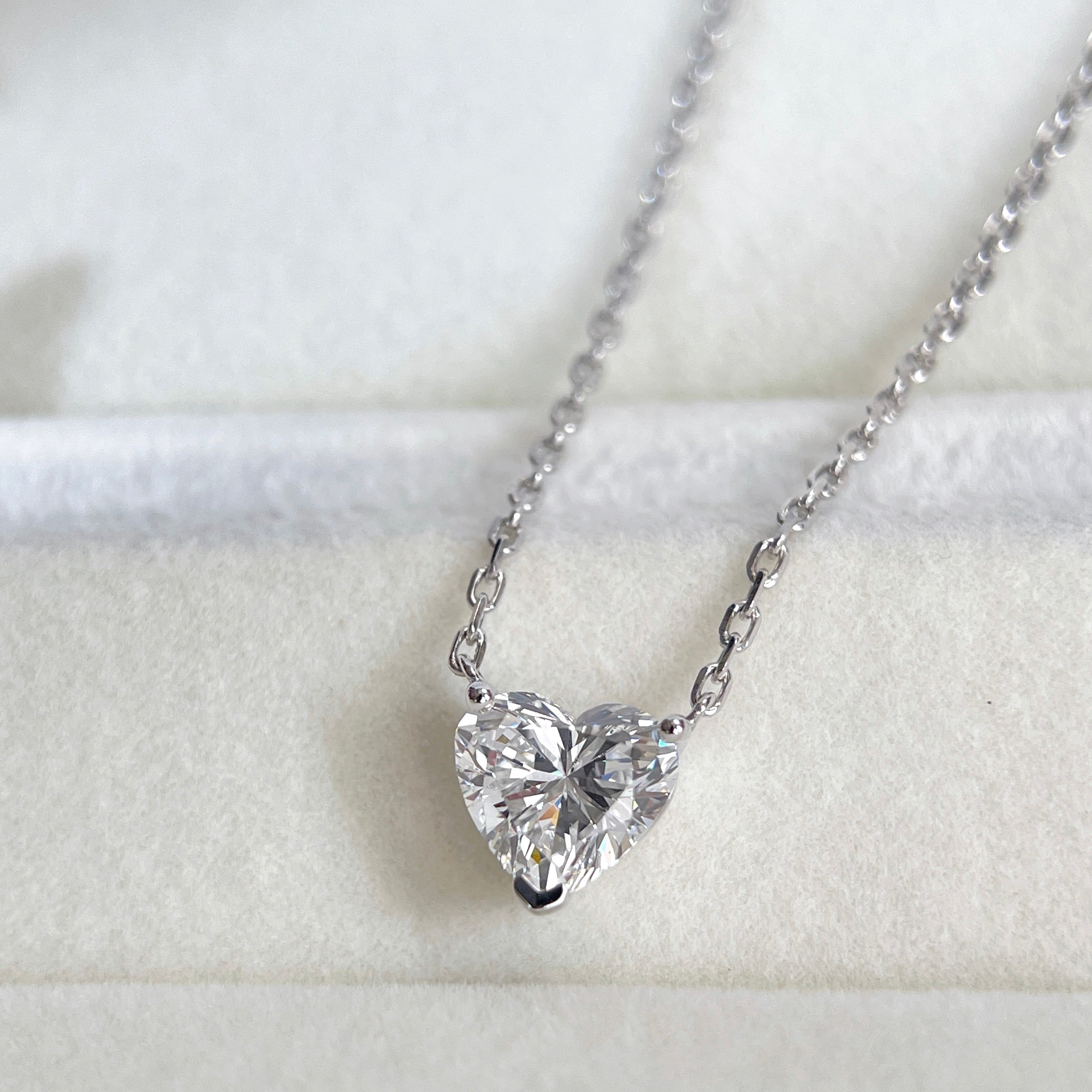 Diamond detail of a 1.51 carat heart-shaped lab grown diamond necklace in 18K white gold.