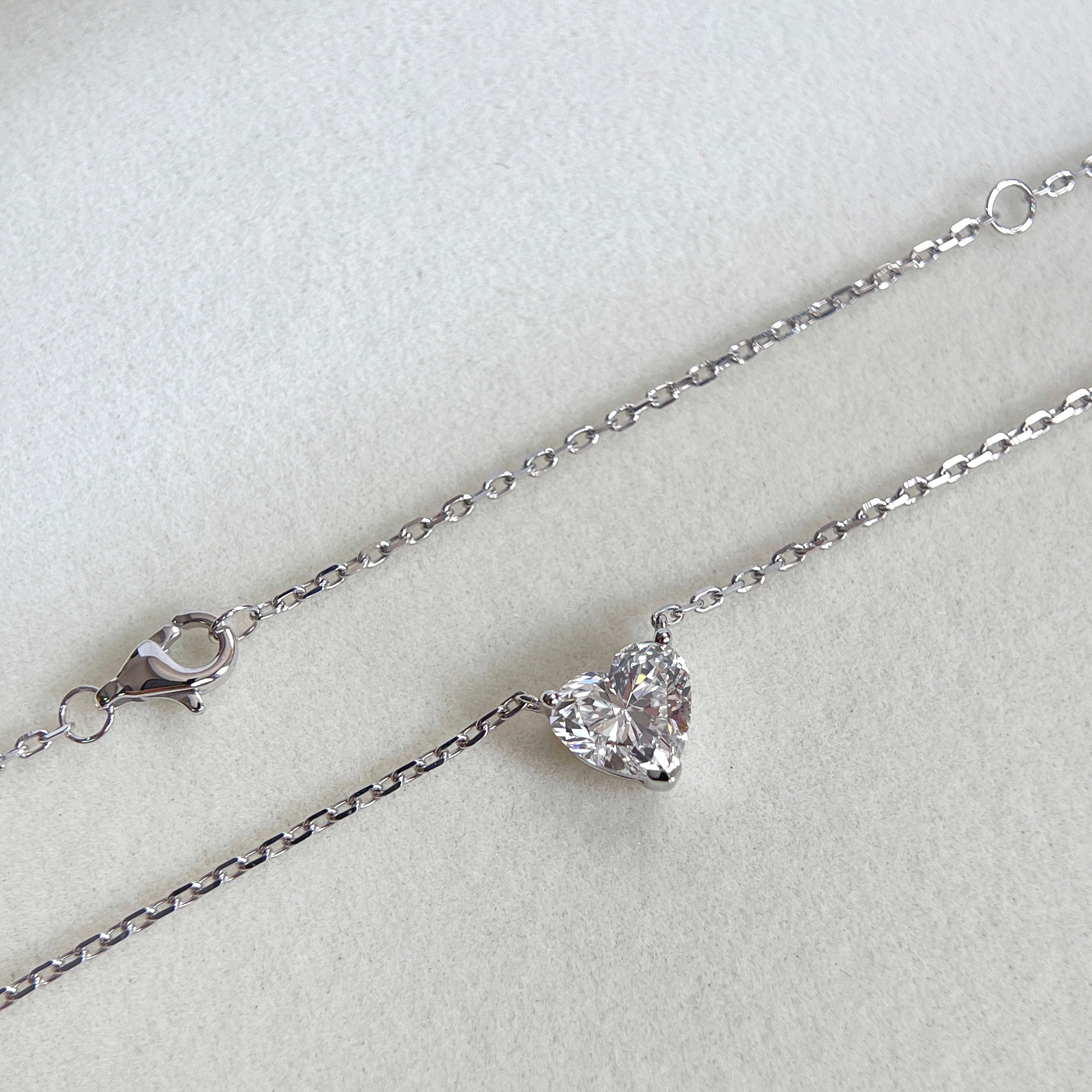 Chain and clasp detail of a 1.51 carat heart-shaped lab grown diamond necklace in 18K white gold.