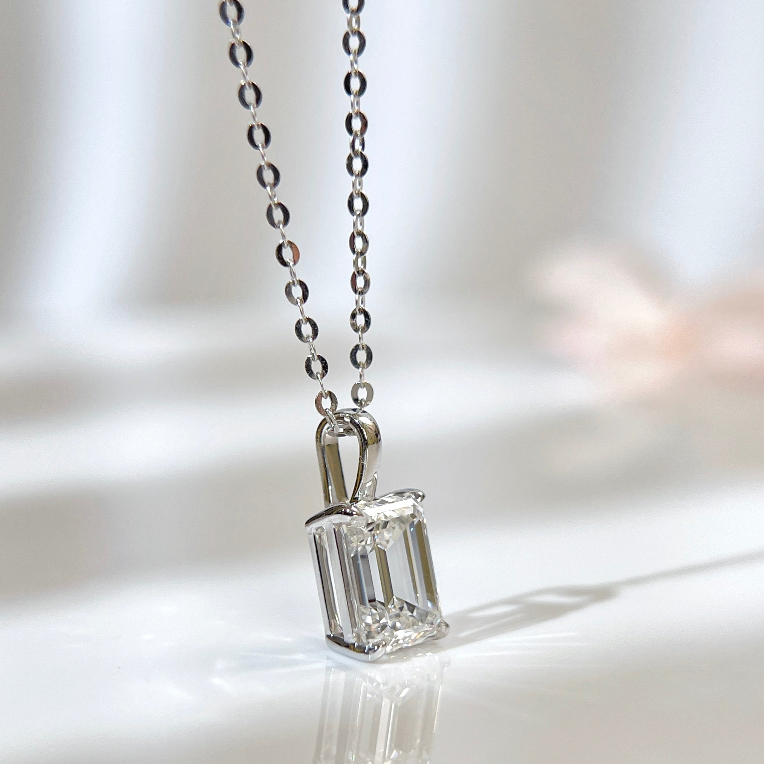 1.5 ct emerald-cut lab grown diamond pendant in 14K white gold styled on a chain