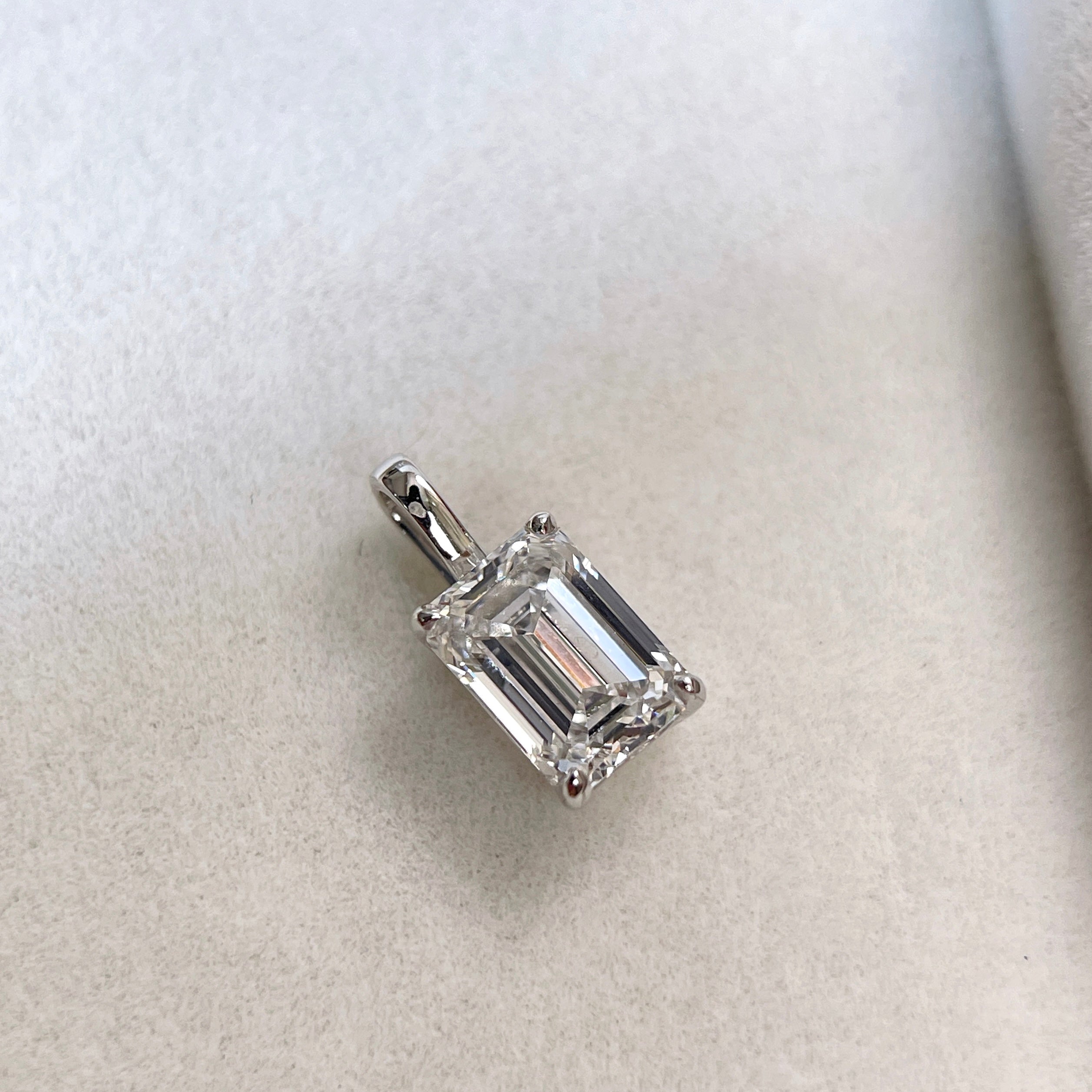 Front view of a standalone 1.5 ct emerald-cut lab grown diamond pendant in 14K white gold