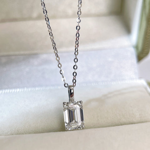 Emerald-cut lab grown diamond 14K white gold pendant styled on a chain in a jewelry box
