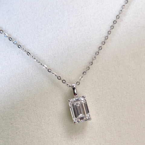 Centered front display of a 1.5 ct emerald-cut lab grown diamond pendant styled on a chain
