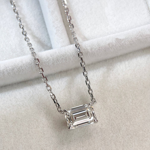 Angled display of a 1.5 ct emerald-cut lab grown diamond solitaire necklace in 18K white gold