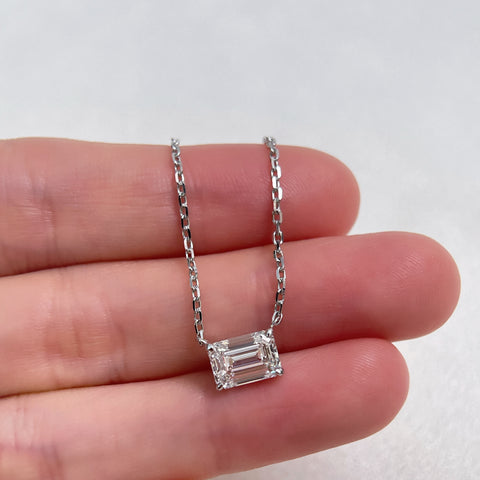 Hand-held view showing the scale of a 1.5 ct emerald-cut lab grown diamond 18K white gold necklace