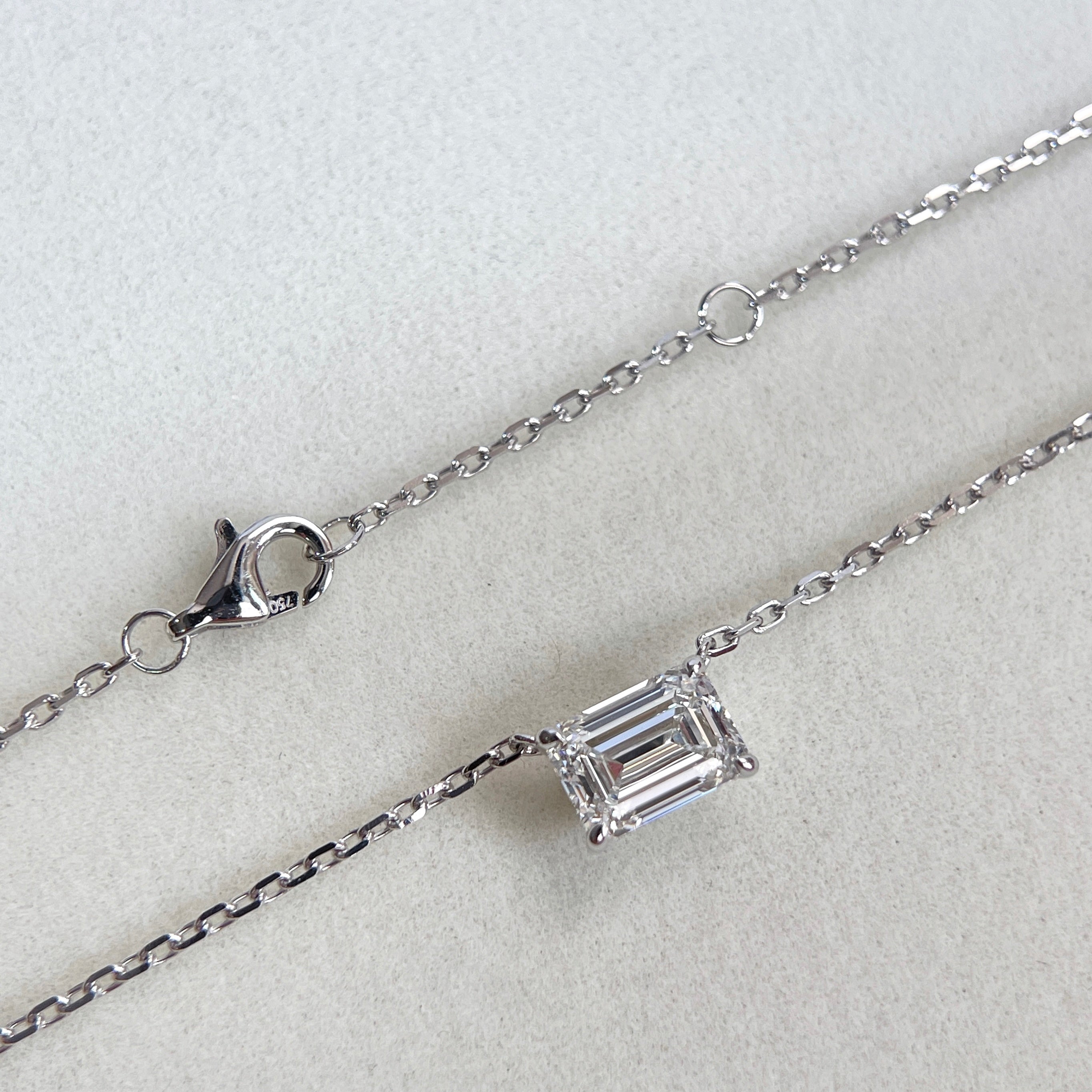 Clasp and adjustment ring detail on an emerald-cut lab grown diamond 18K white gold necklace