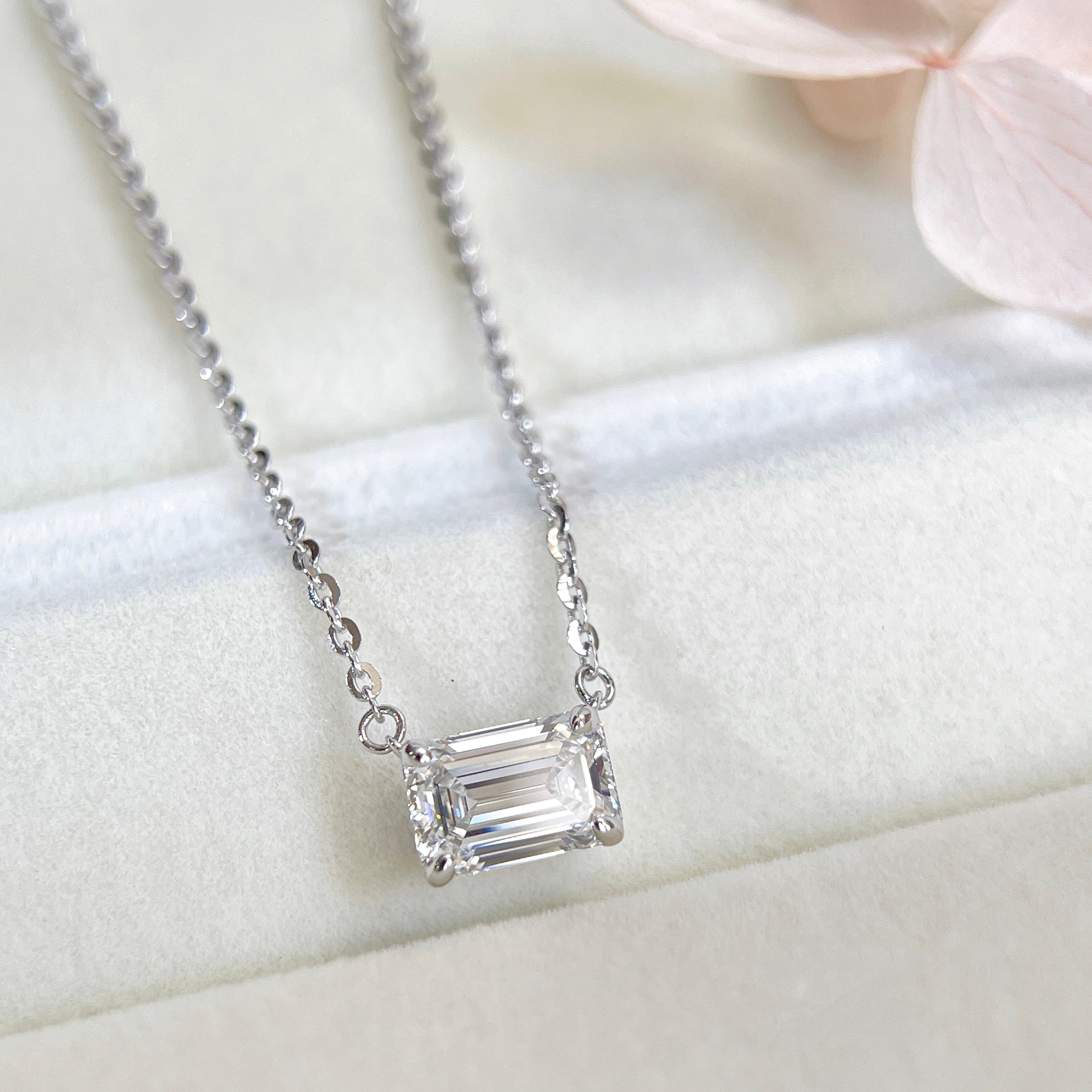 Emerald-cut lab grown diamond sterling silver necklace displayed in a jewelry box