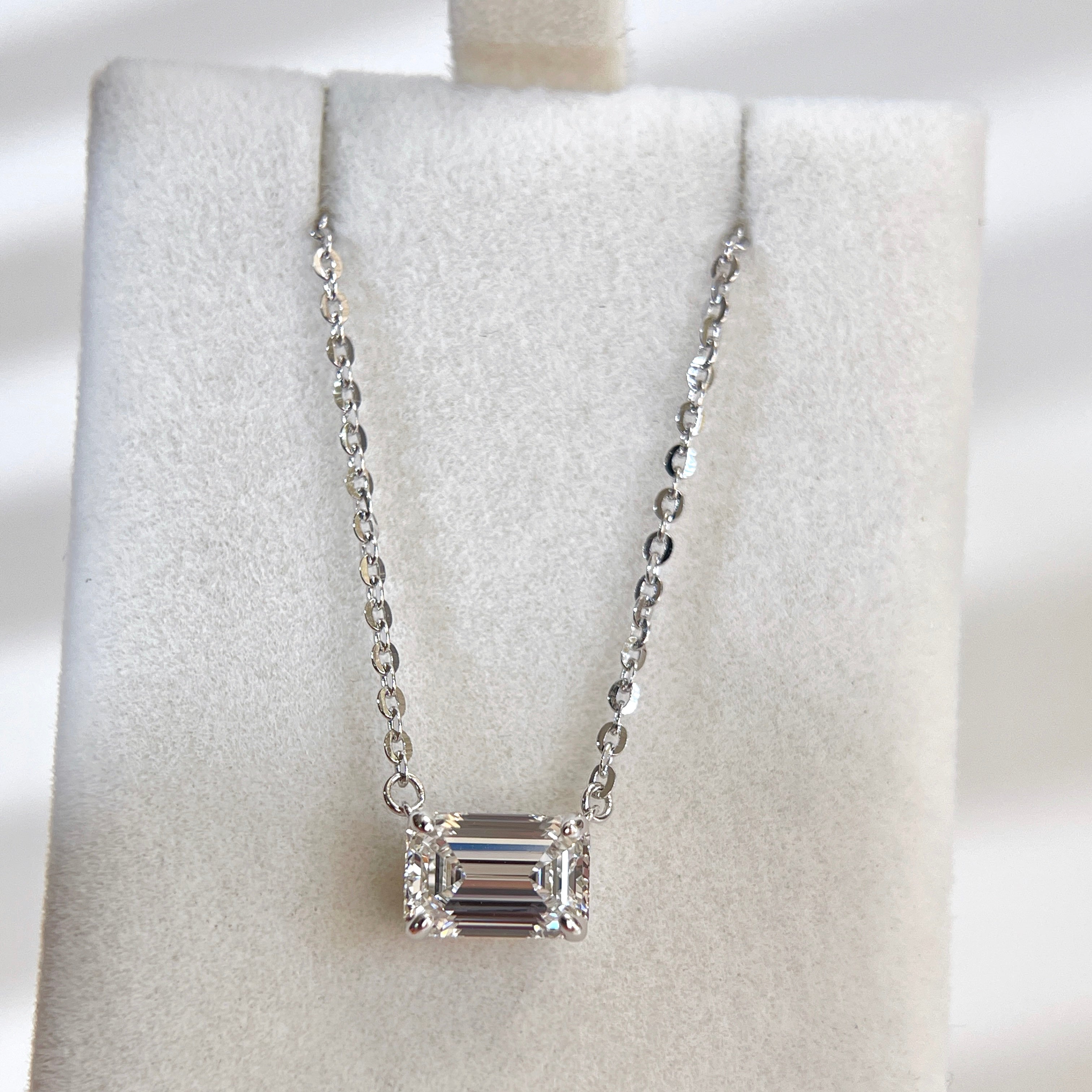 Wide display of a 1.5 ct emerald-cut lab grown diamond necklace with a sterling silver chain