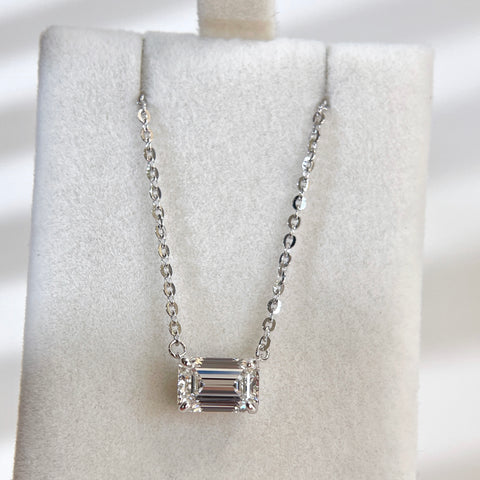 Wide display of a 1.5 ct emerald-cut lab grown diamond necklace with a sterling silver chain