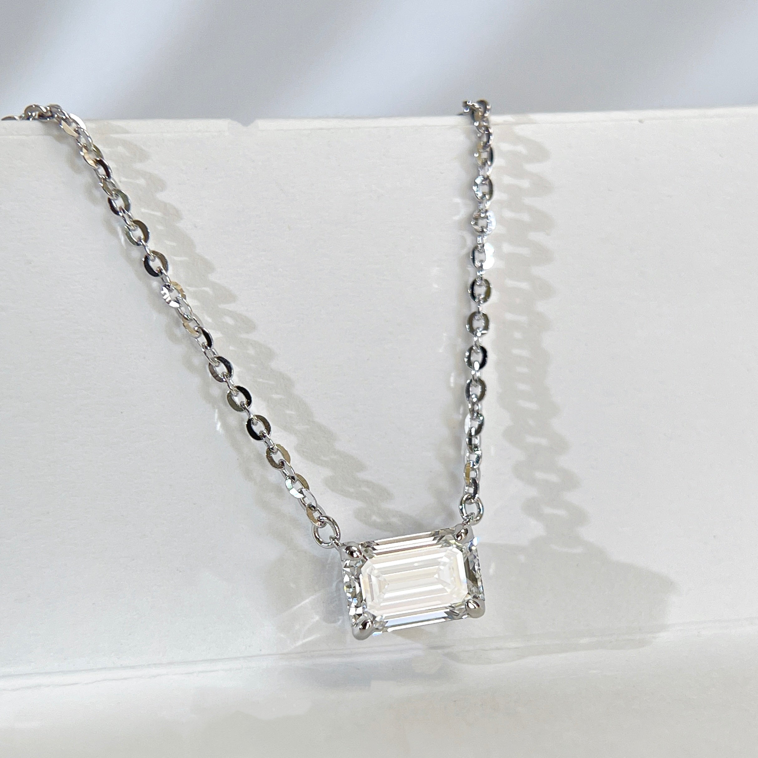 Close display view of a 1.5 ct emerald-cut lab grown diamond sterling silver necklace