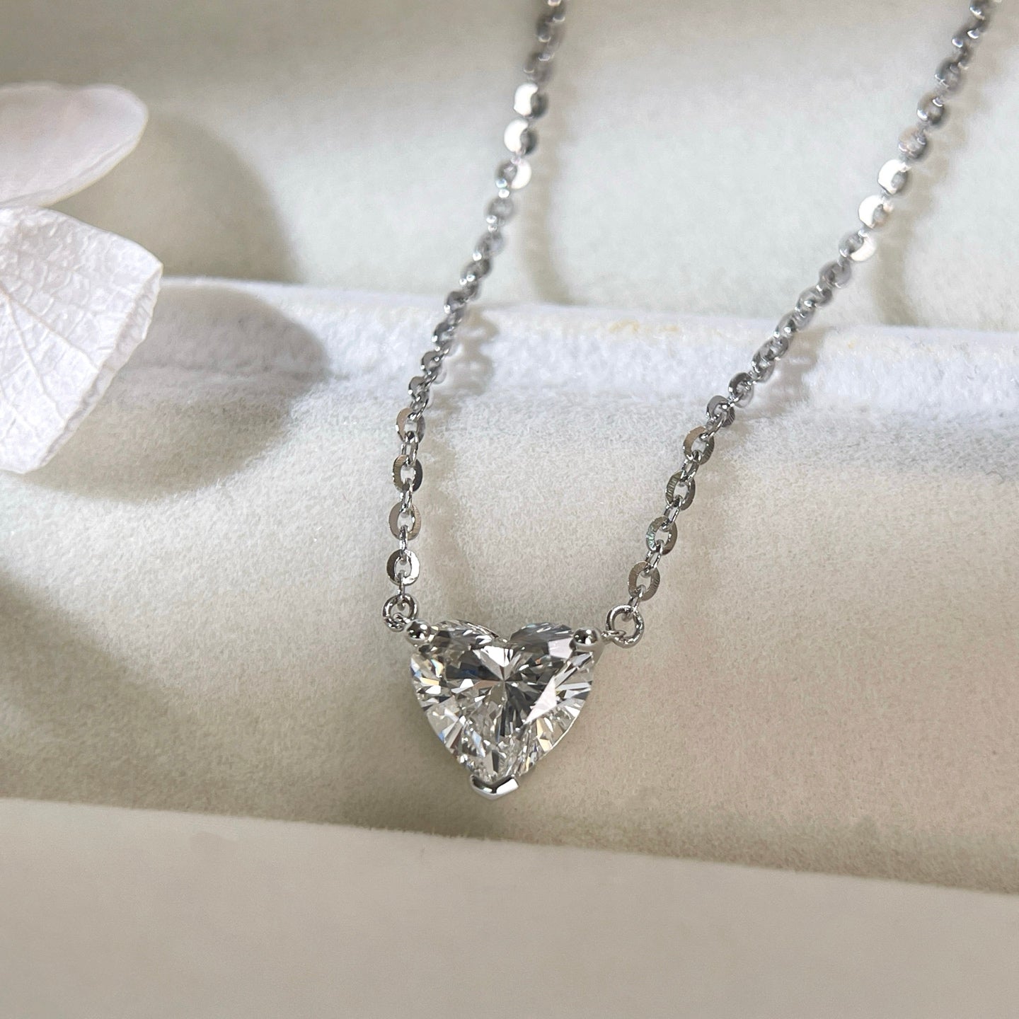 Jewelry display of a 1.5 carat heart-shaped lab grown diamond necklace in S925 sterling silver.