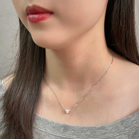 Side-profile view of a model wearing a 1.5 carat heart-shaped lab grown diamond necklace in S925 sterling silver.