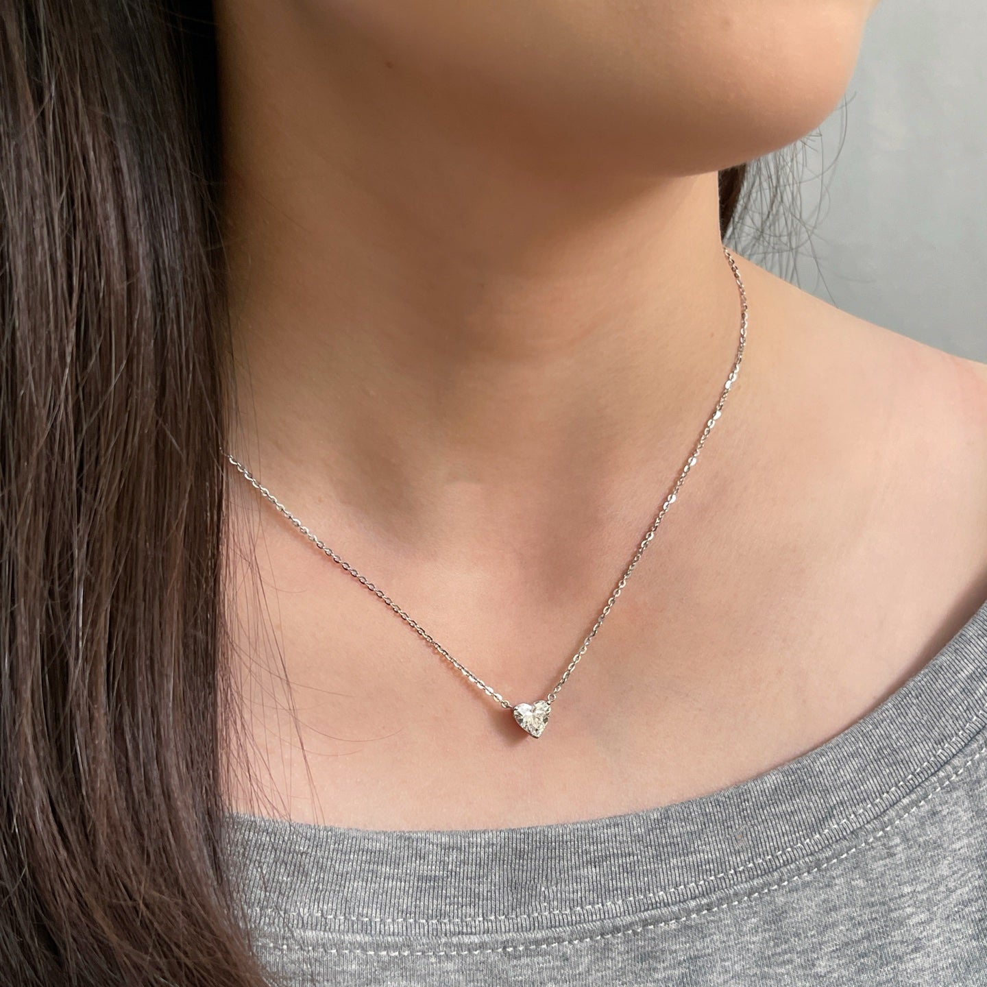 Model wearing a 1.5 carat heart-shaped lab grown diamond necklace in S925 sterling silver.