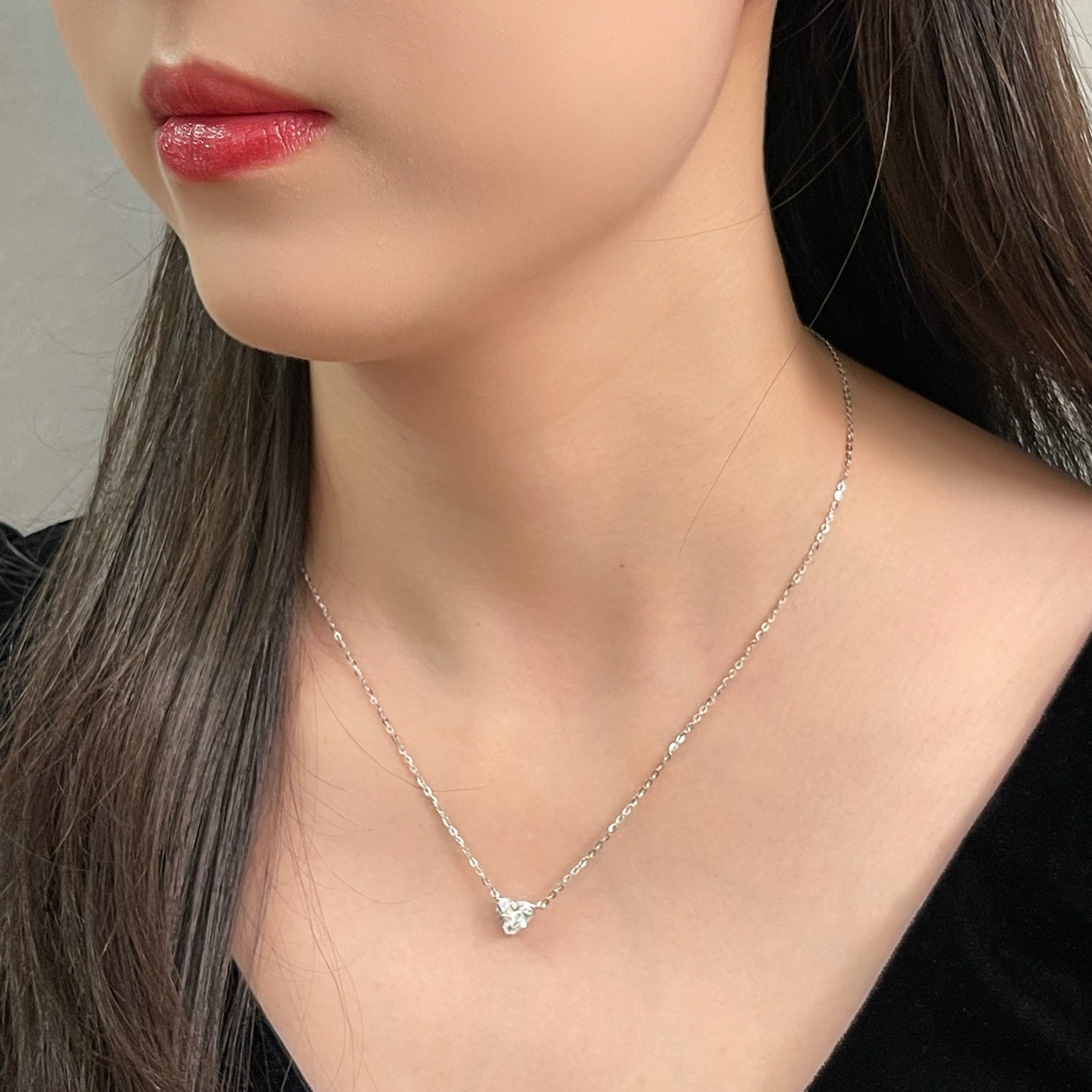 Close-up of a model wearing a 1.5 carat heart-shaped lab grown diamond necklace in S925 sterling silver.