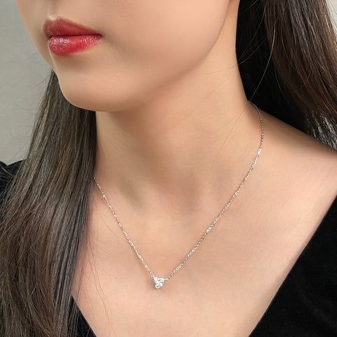 Close-up of a model wearing a 1.5 carat heart-shaped lab grown diamond necklace in S925 sterling silver.