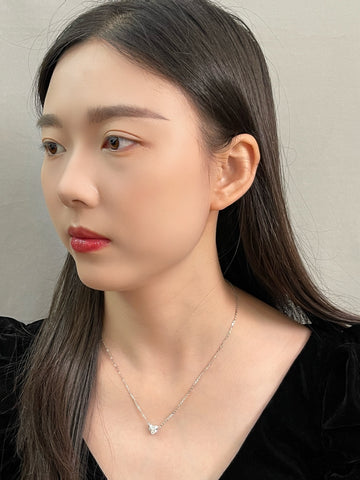Portrait of a model wearing a 1.5 carat heart-shaped lab grown diamond necklace in S925 sterling silver.