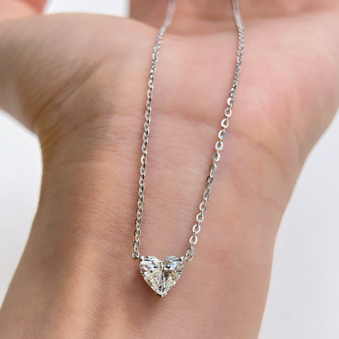 Displayed on a hand: a 1.5 carat heart-shaped lab grown diamond necklace in S925 sterling silver.