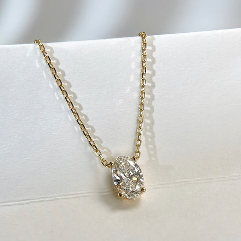 Angled display of a four-prong oval lab-grown diamond necklace