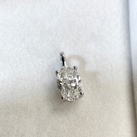 Front view of a 1.5 carat oval lab-grown diamond four-prong pendant