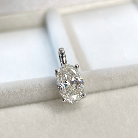 Angled view of an oval lab-grown diamond pendant in 14K white gold