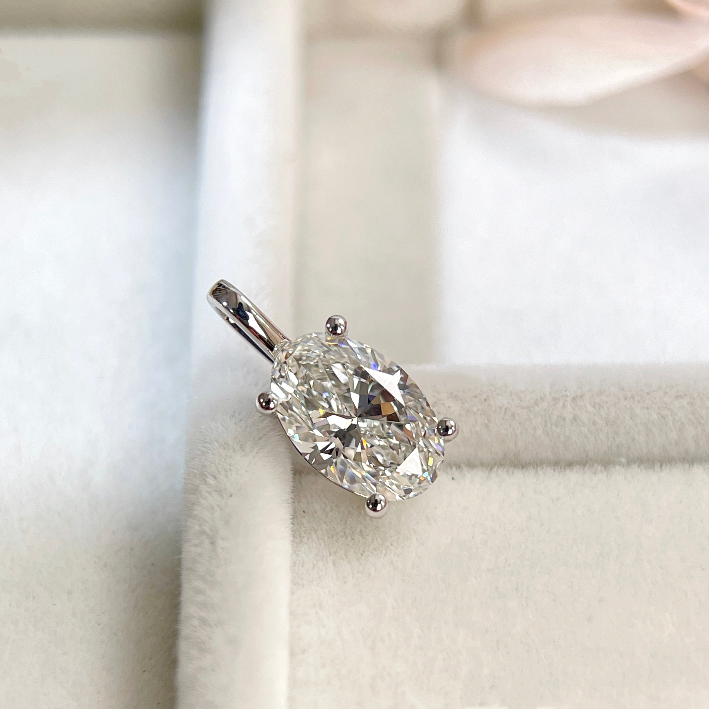 Display angle of a 1.5 carat oval lab-grown diamond four-prong pendant