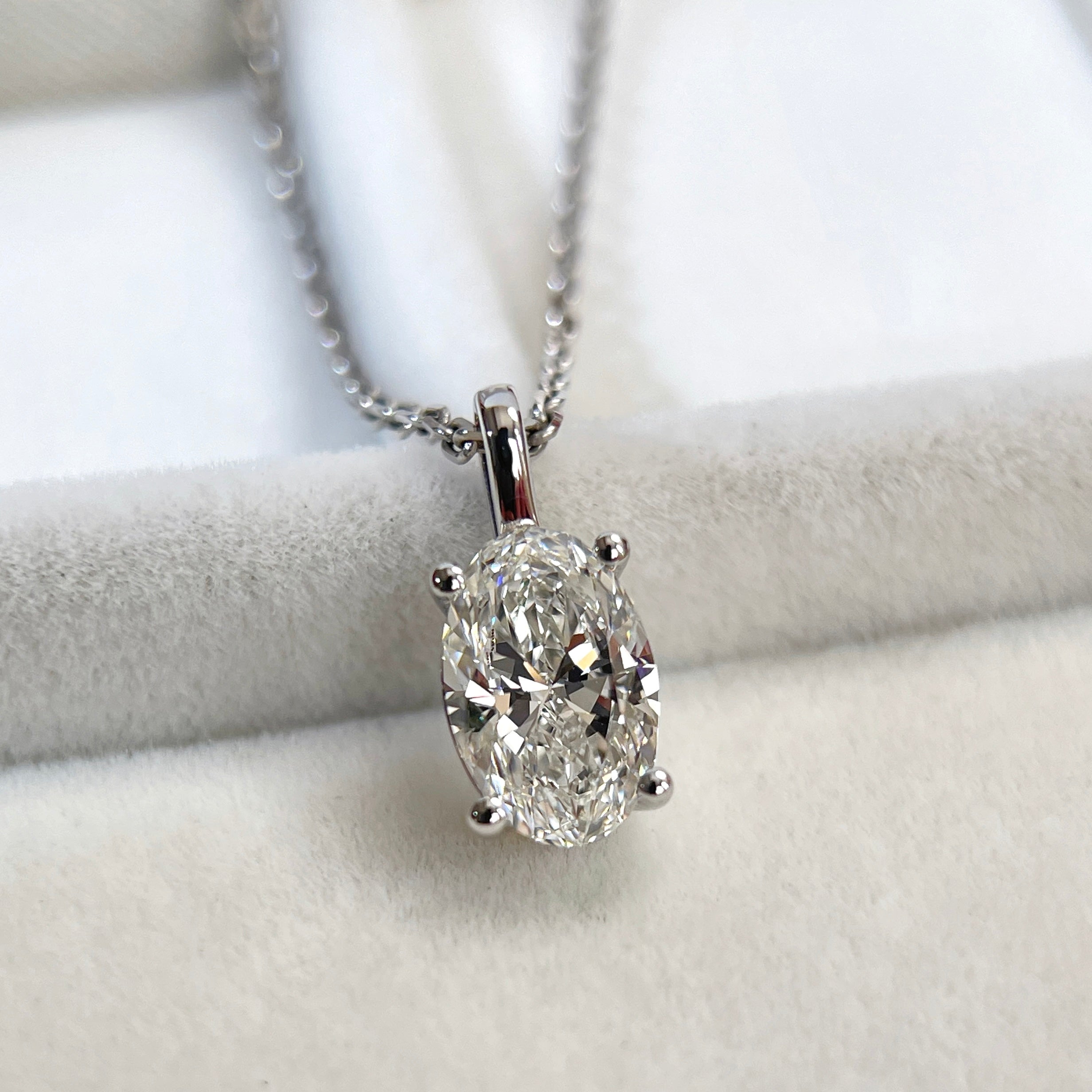 Close-up of an oval lab-grown diamond pendant shown on a chain for styling