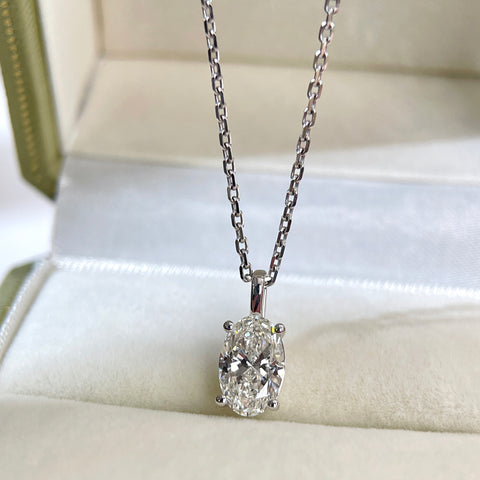 Full display of a four-prong oval lab-grown diamond pendant shown on a chain
