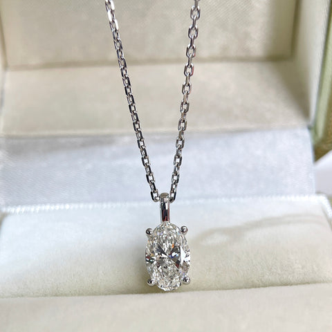 Oval lab-grown diamond pendant styled on a chain in a jewelry box