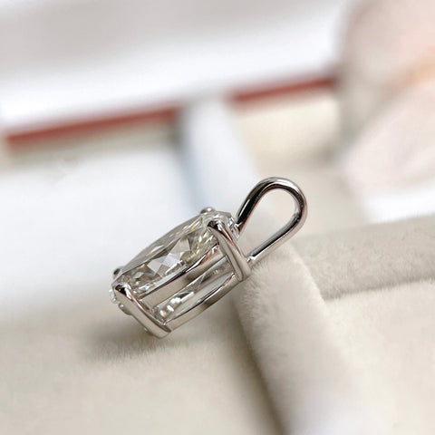 Side view showing the four-prong basket of an oval lab-grown diamond pendant