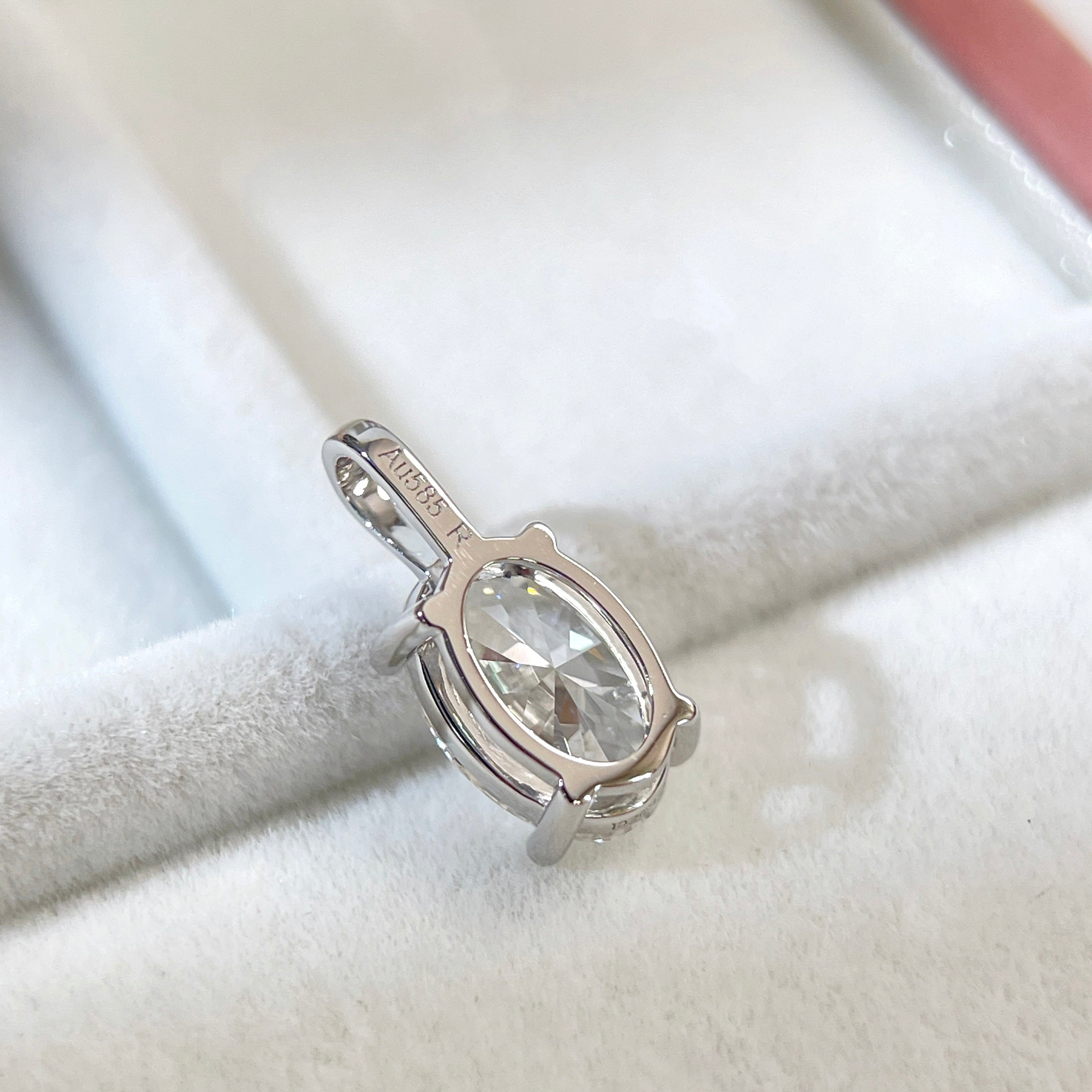 Back view of a 14K white gold oval lab-grown diamond four-prong pendant