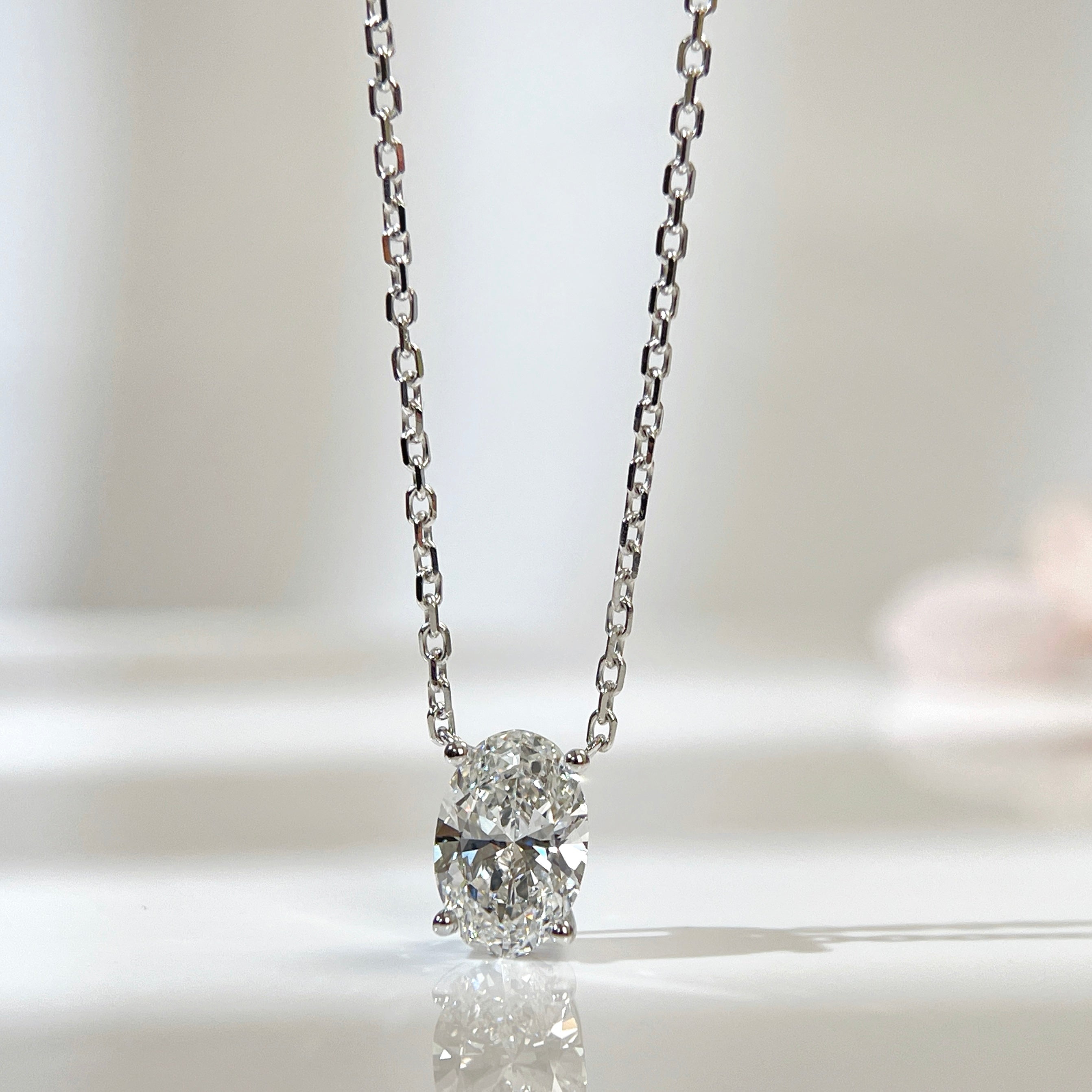 Front presentation of a 1.58 carat oval lab grown diamond necklace in 18K white gold.