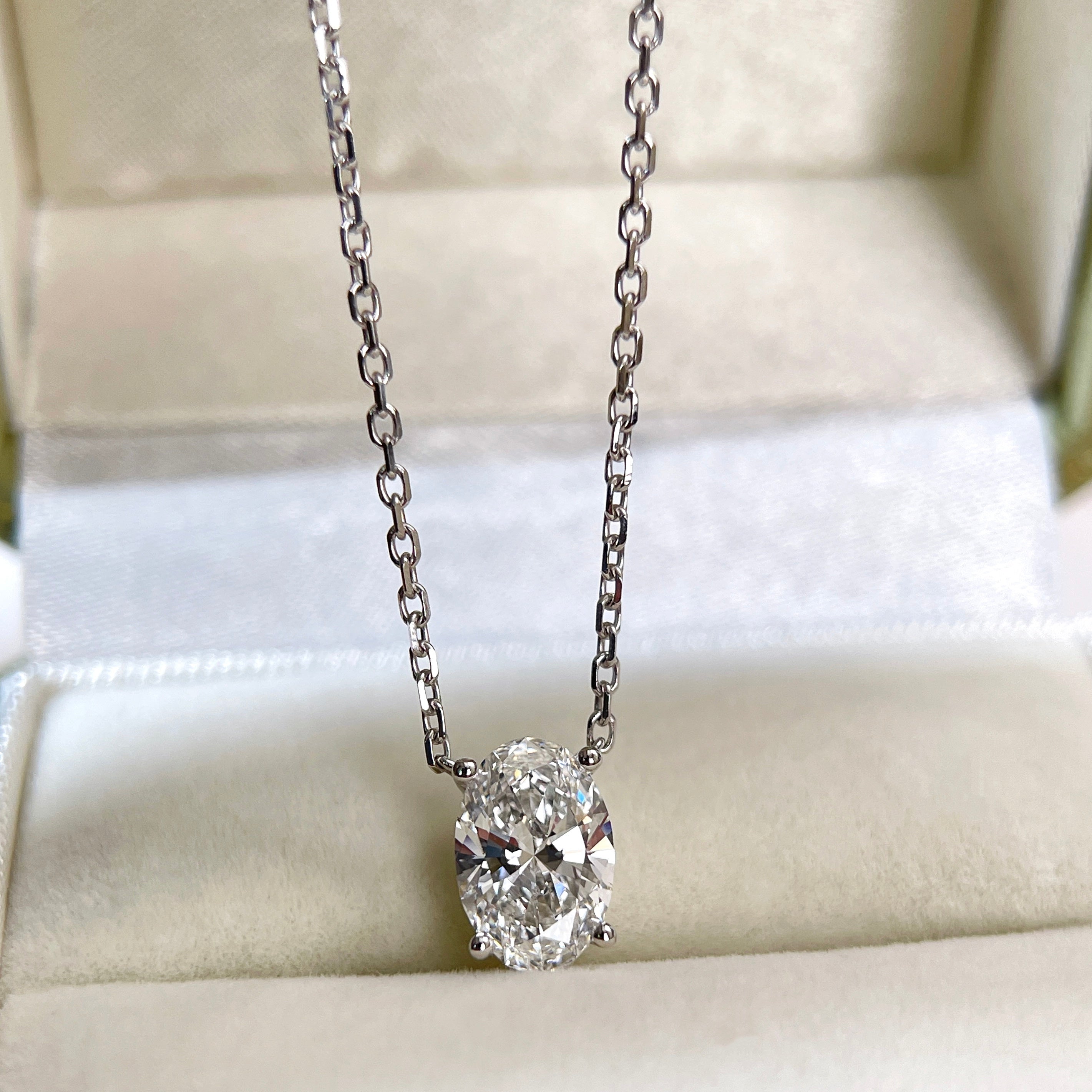 Front view of a 1.58 carat oval lab grown diamond necklace in 18K white gold.