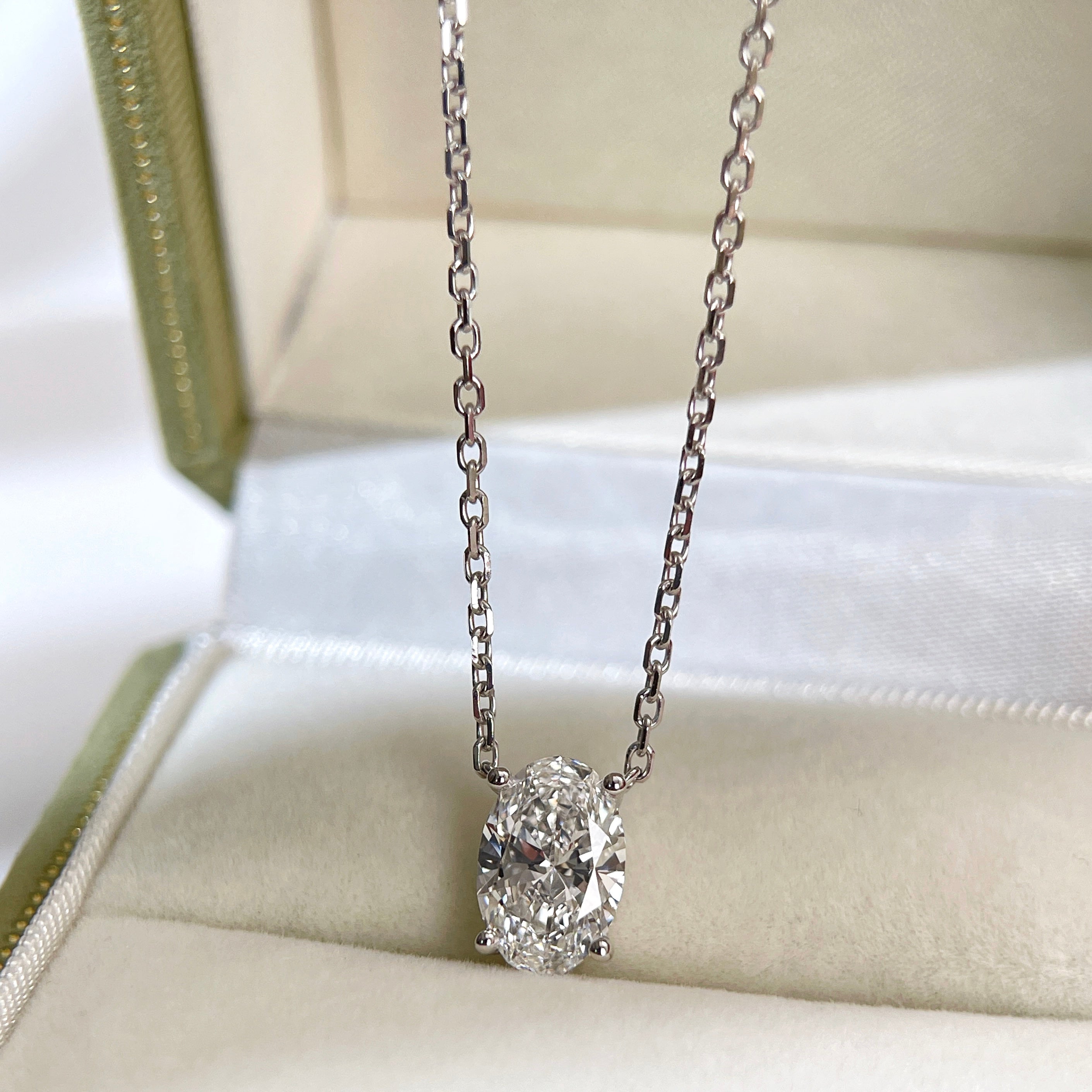 Jewelry display of a 1.58 carat oval lab grown diamond necklace in 18K white gold.