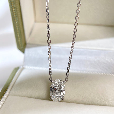 Jewelry display of a 1.58 carat oval lab grown diamond necklace in 18K white gold.