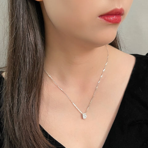 Model wearing a 1.58 carat oval lab grown diamond necklace in 18K white gold.