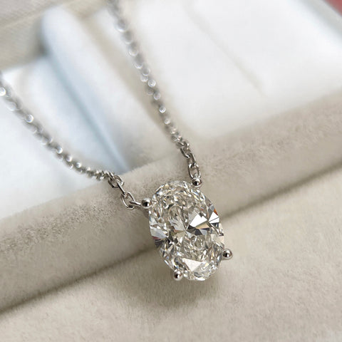 Close-up of a 1.58 carat oval lab grown diamond necklace in 18K white gold.