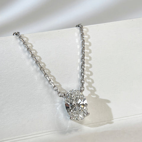 Angled view of a 1.58 carat oval lab grown diamond necklace in 18K white gold.