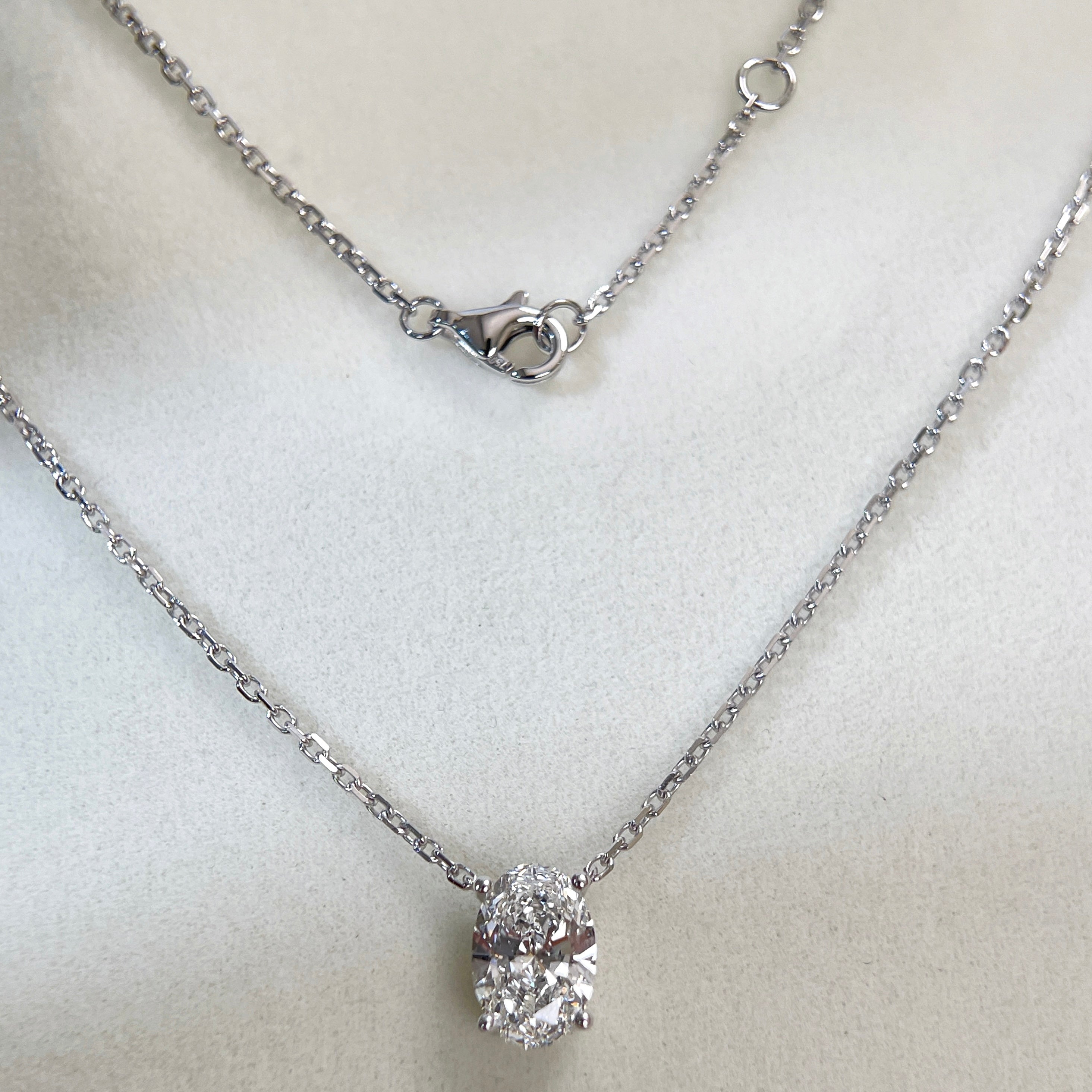 Full necklace and clasp display of a 1.58 carat oval lab grown diamond necklace in 18K white gold.