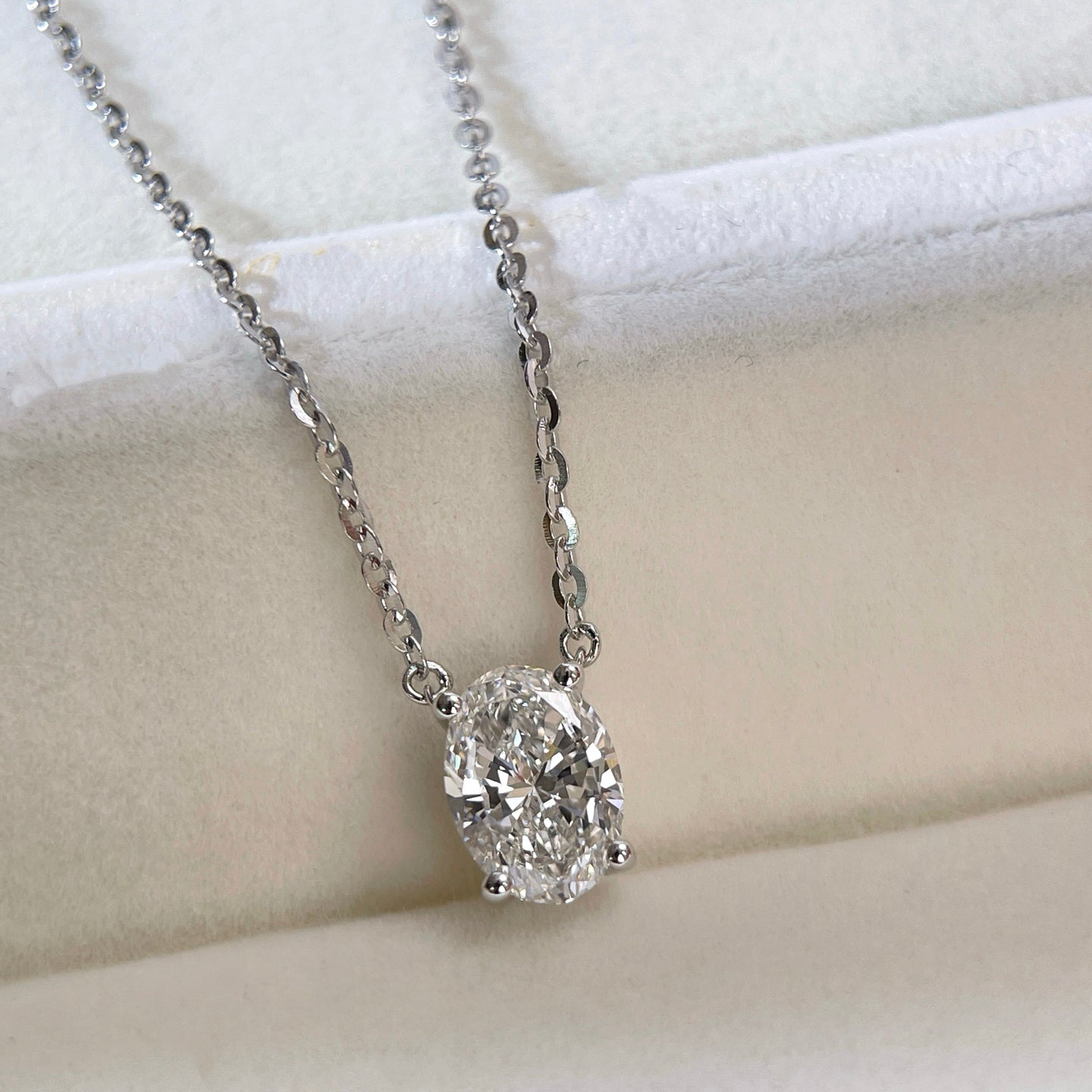 Jewelry display of a 1.5 carat oval lab grown diamond necklace in S925 sterling silver.