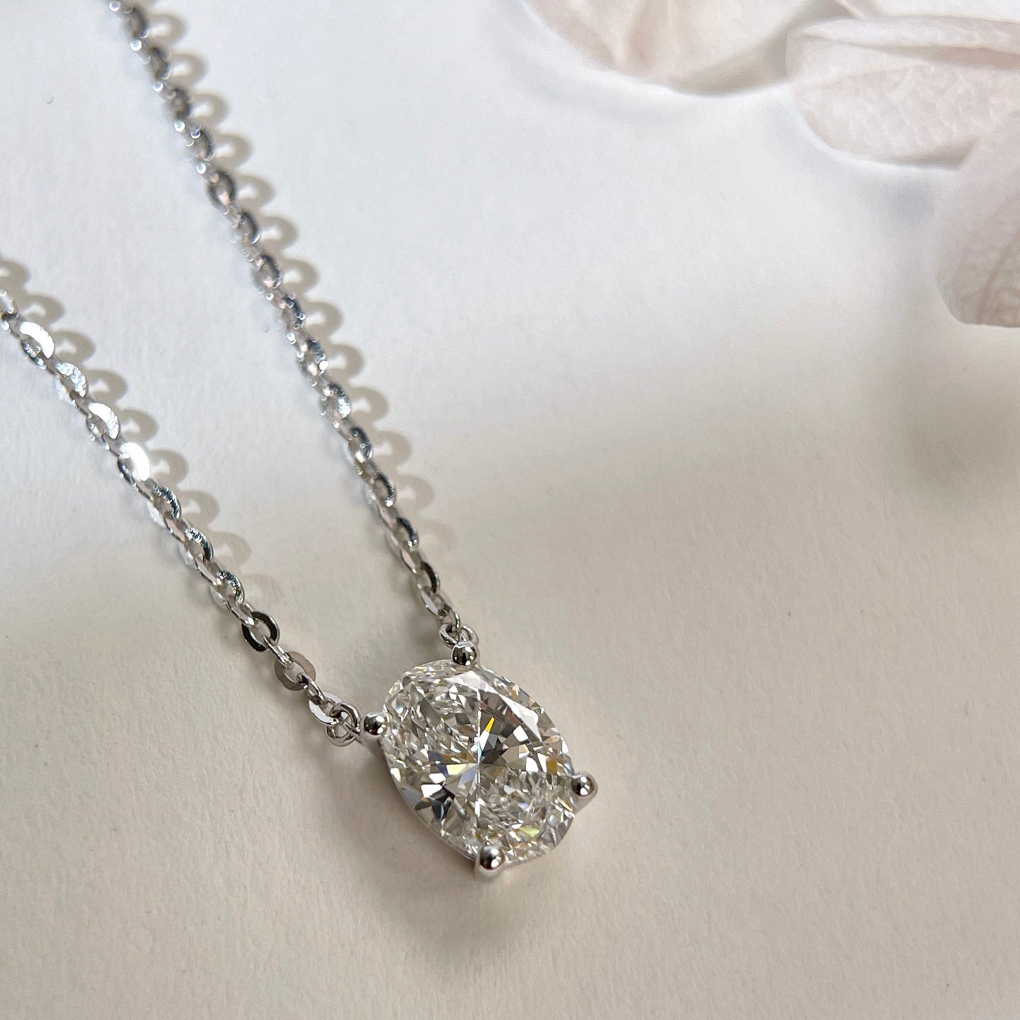 Close-up of a 1.5 carat oval lab grown diamond necklace in S925 sterling silver.