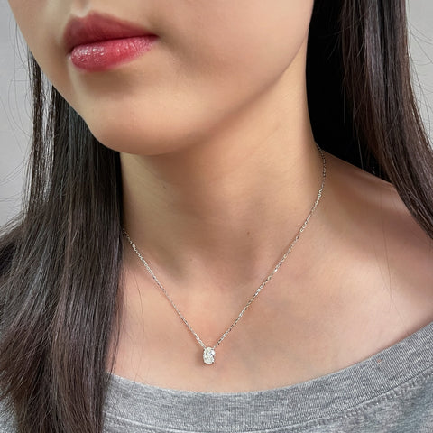 Model wearing a 1.5 carat oval lab grown diamond necklace in S925 sterling silver.