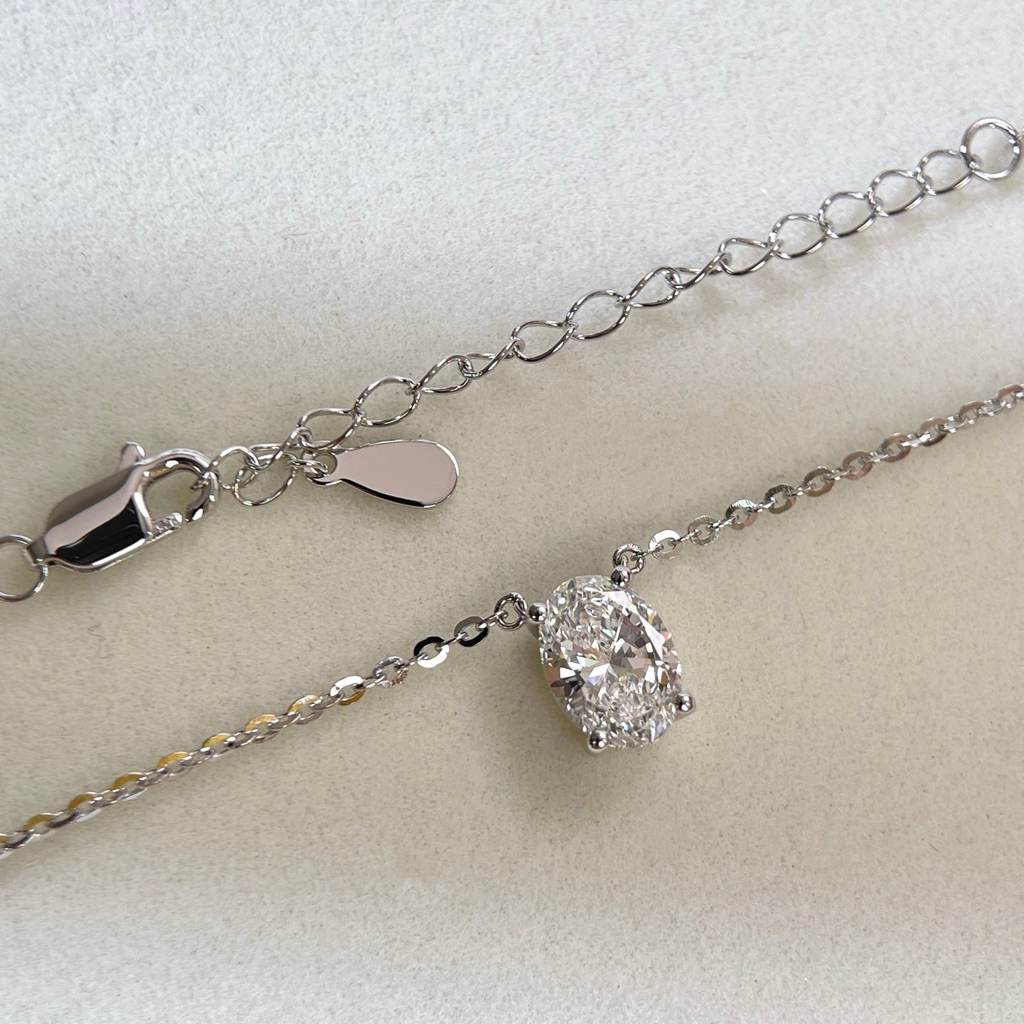 Adjustable extender and clasp detail of a 1.5 carat oval lab grown diamond necklace in S925 sterling silver.