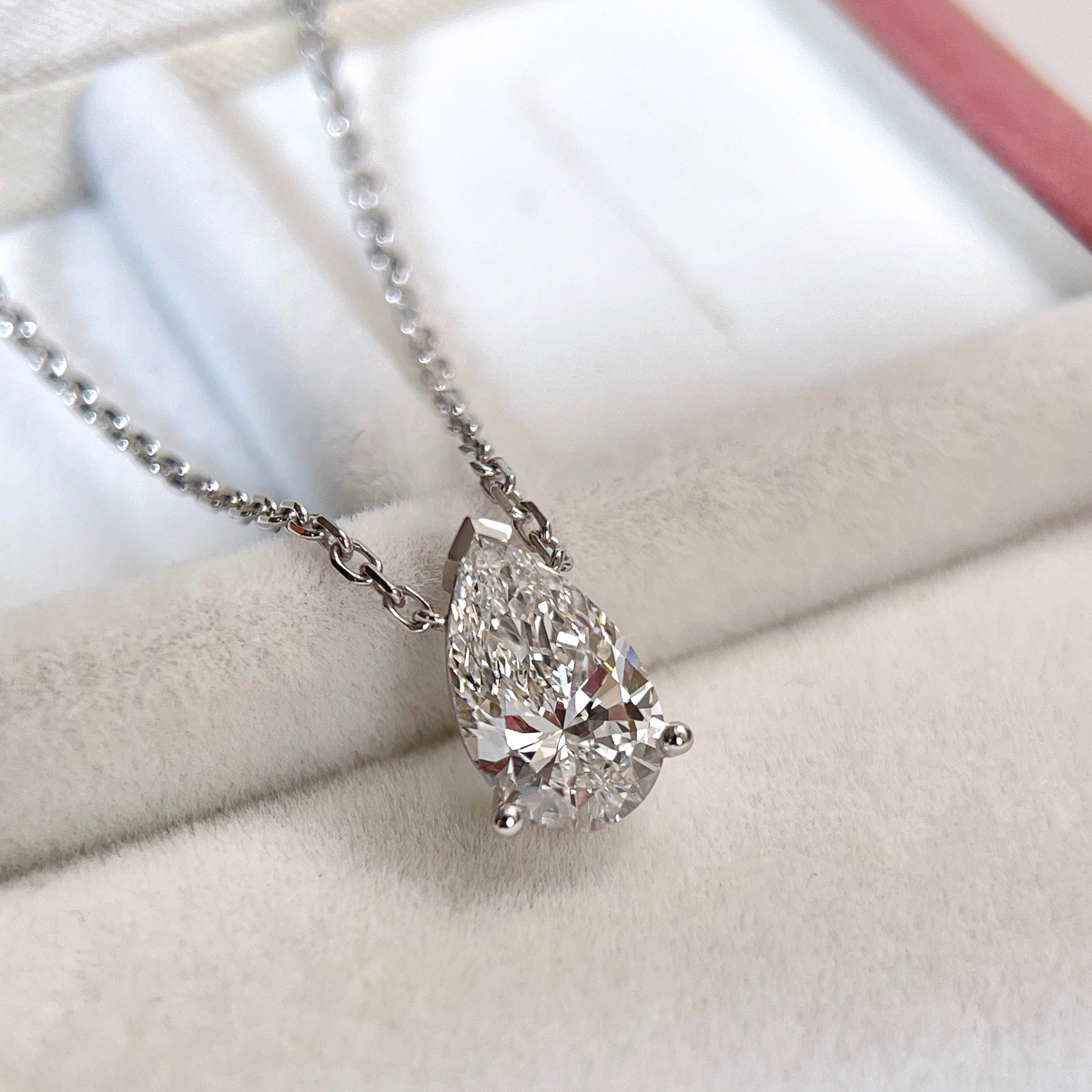 Angled front view of a 1.5 carat pear lab grown diamond necklace in 18K white gold.
