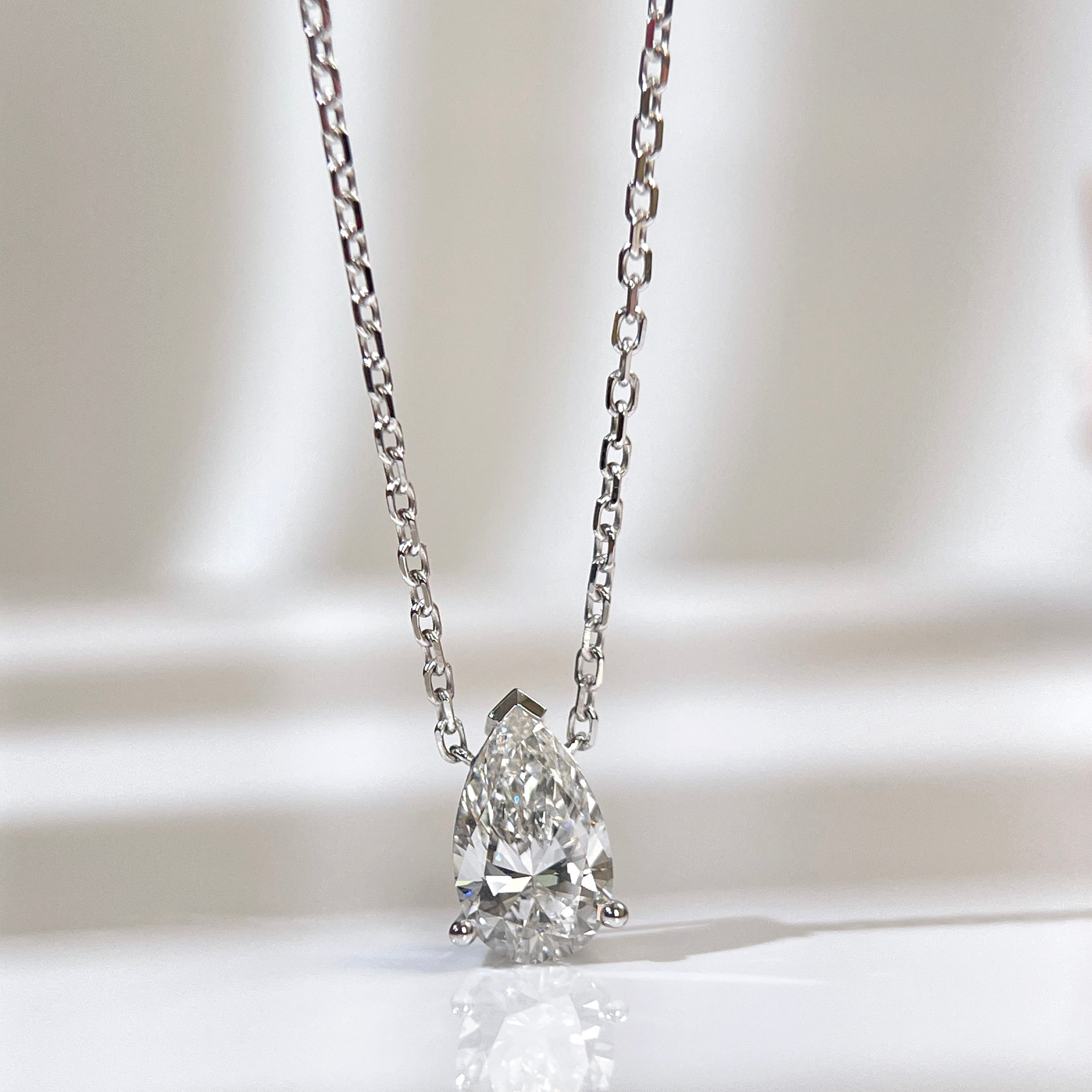 Front presentation of a 1.5 carat pear lab grown diamond necklace in 18K white gold.
