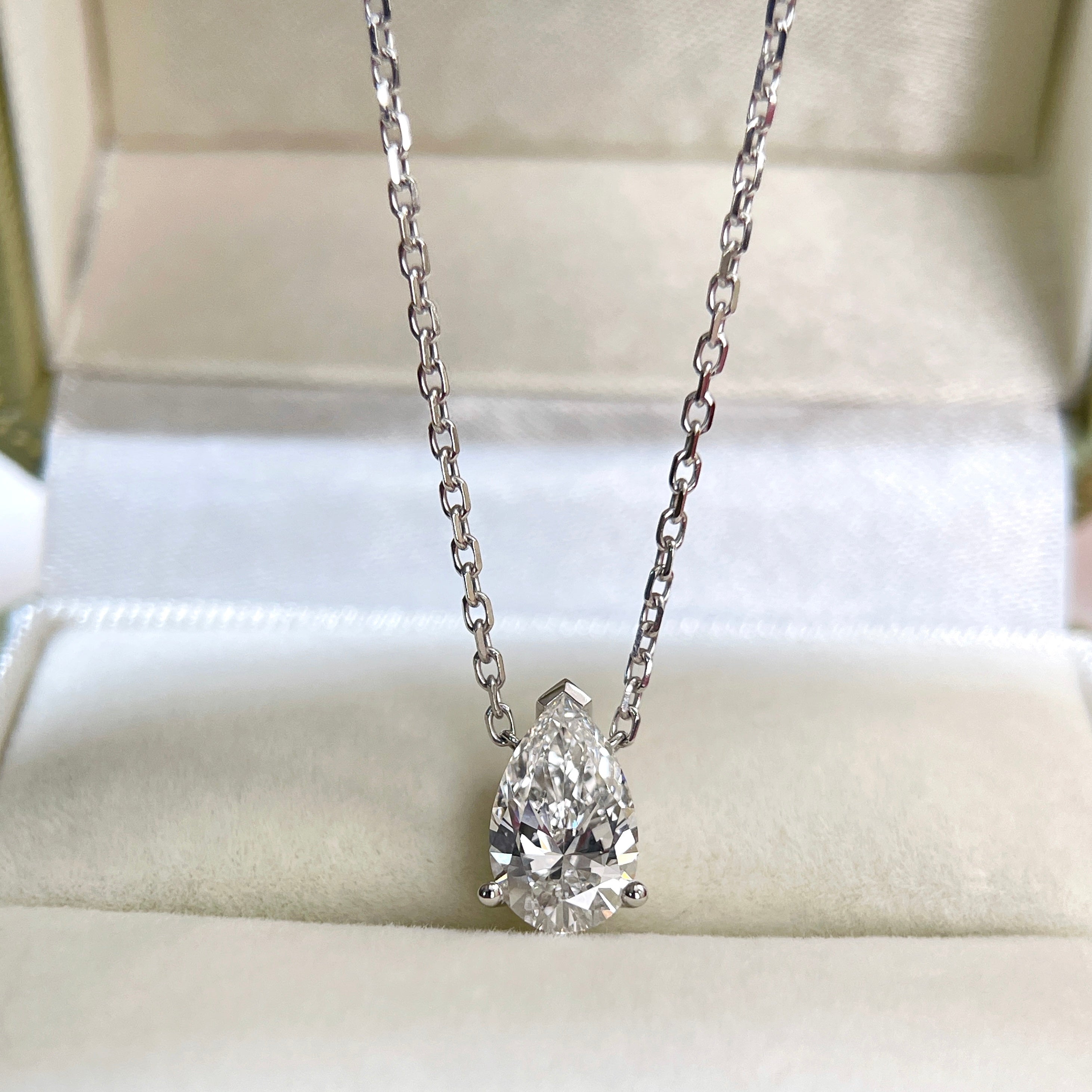 Front view of a 1.5 carat pear lab grown diamond necklace in 18K white gold.