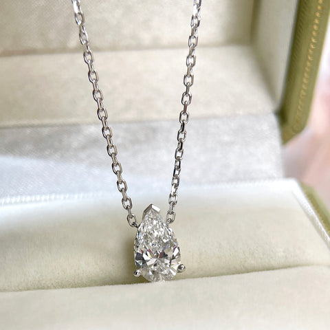 Jewelry display of a 1.5 carat pear lab grown diamond necklace in 18K white gold.