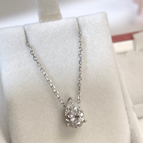Jewelry display of a 1.5 carat pear lab grown diamond necklace in 18K white gold.