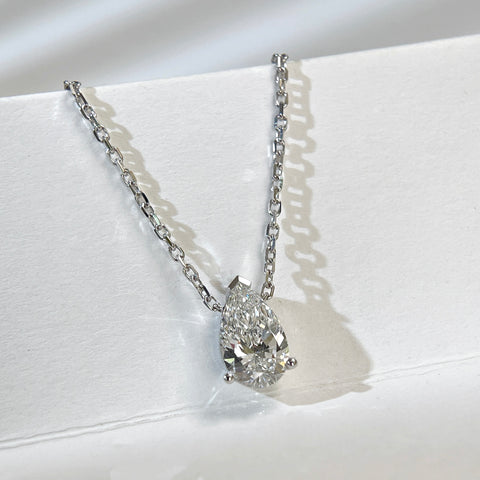 Diamond detail of a 1.5 carat pear lab grown diamond necklace in 18K white gold.