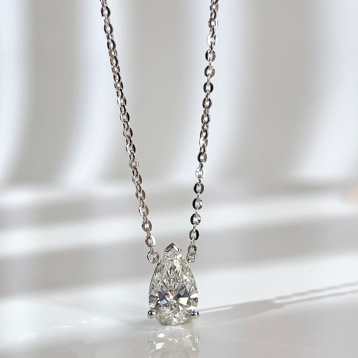 Front view of a 1.5 carat pear lab grown diamond necklace in S925 sterling silver.