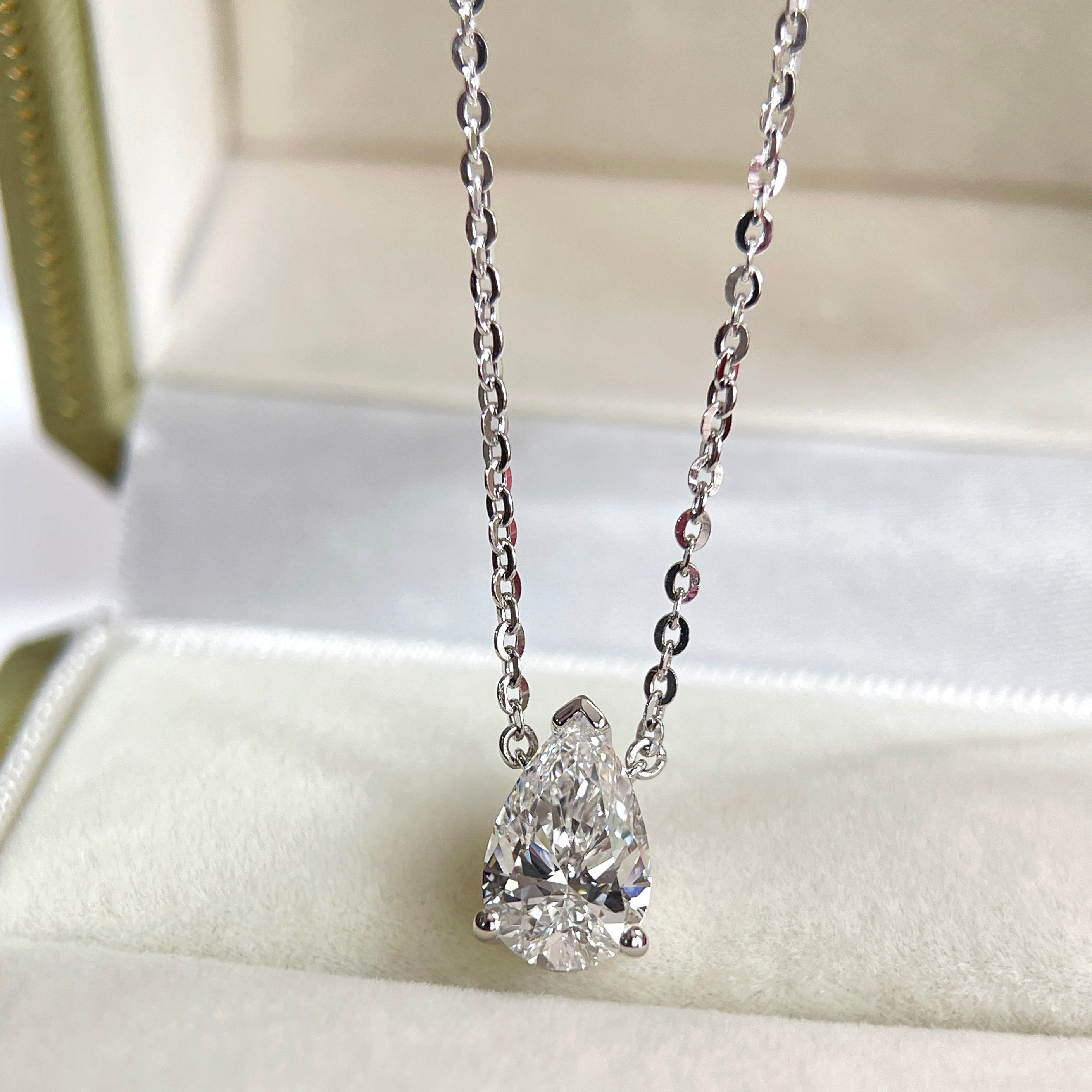 Display on a jewelry box of a 1.5 carat pear lab grown diamond necklace in S925 sterling silver.