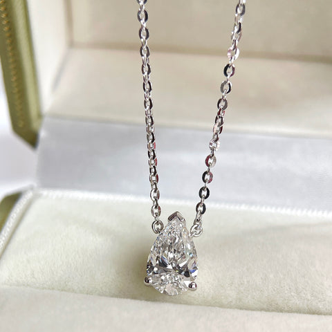 Display on a jewelry box of a 1.5 carat pear lab grown diamond necklace in S925 sterling silver.